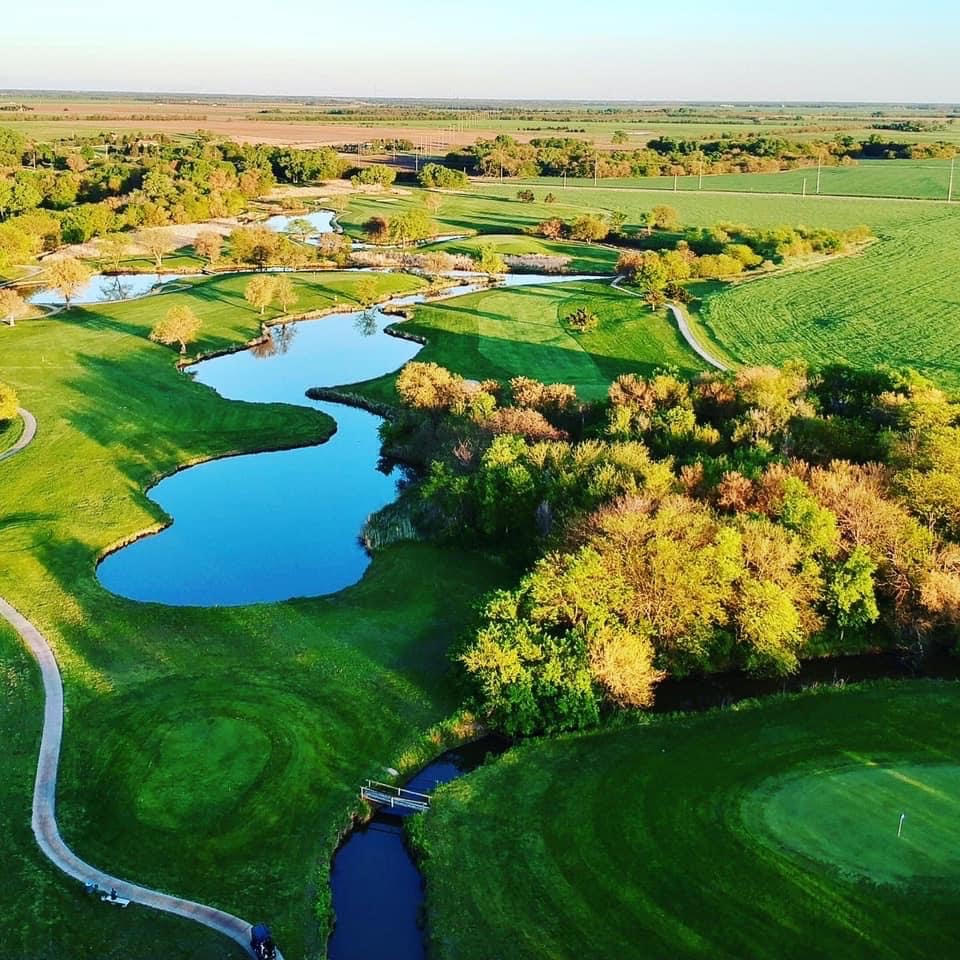 Pond on golf course next to cart path 